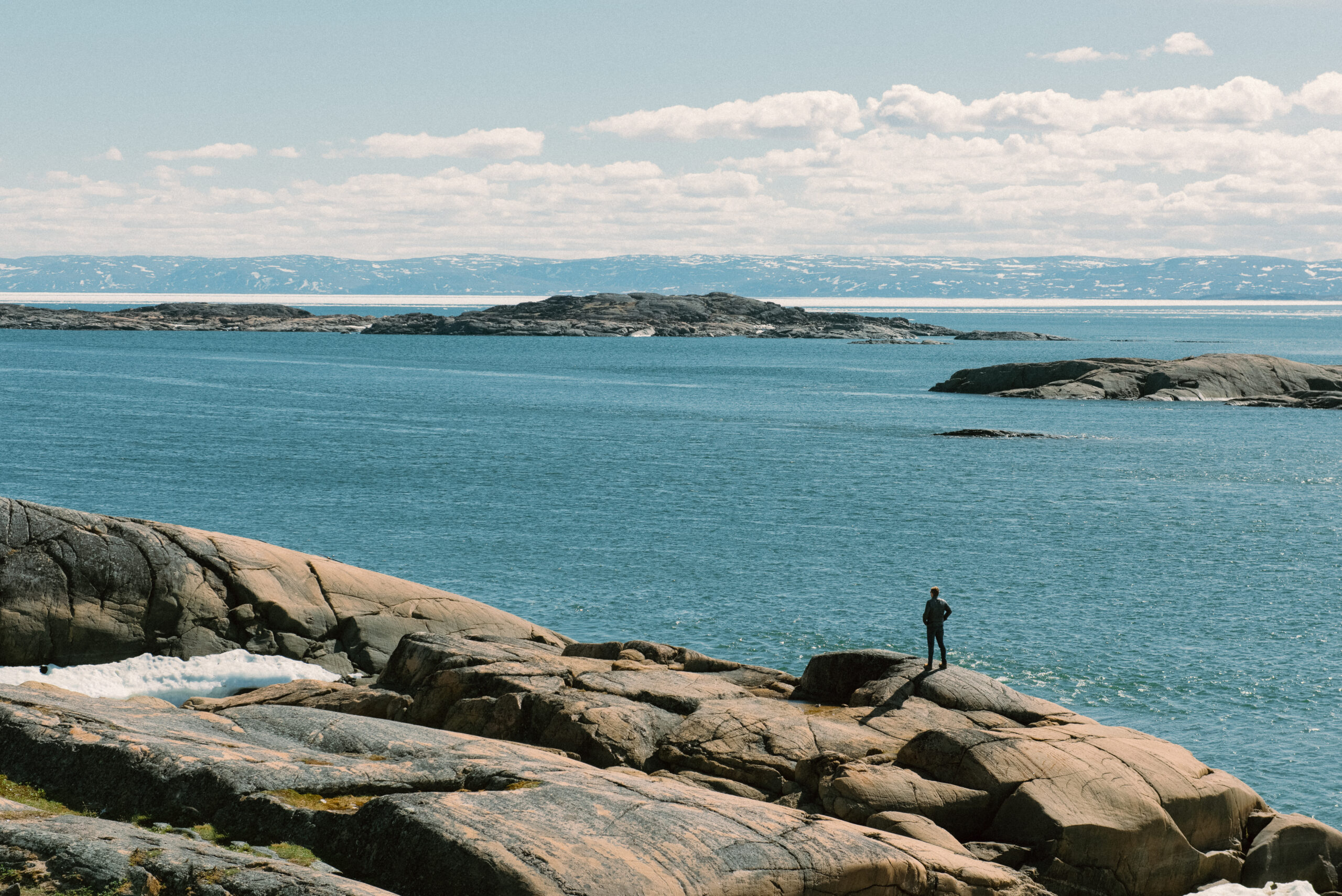 A man overlooks the inlet of Frobisher Bay from Sylvia Grinnel Territorial Park near Iqaluit, Nunavut, Canada. June 30, 2017